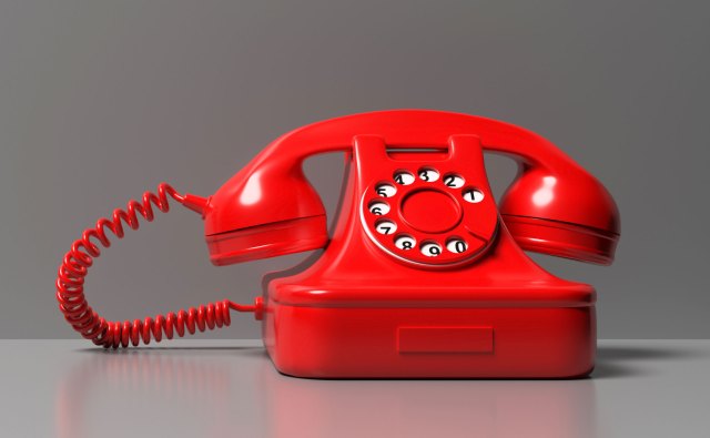 A bright red old fashioned telephone