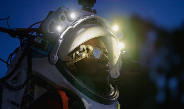 NASA astronaut Andre Douglas wears Augmented Reality display technology during a nighttime advanced technology run in the San Francisco Volcanic Field in Northern Arizona on May 21, 2024.