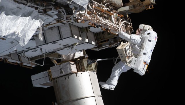 An astronaut performing a spacewalk outside the International Space Station
