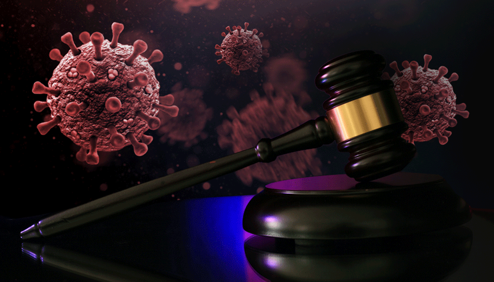 A judge's gavel in front of illustrations of floating COVID-19 particles