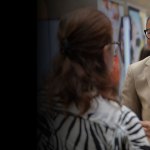 Makayla Gilliam smiling and speaking to an attendee at a career fair