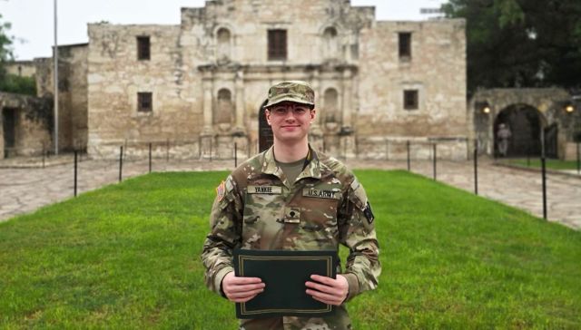 Caleb Yankee in uniform smiling outside