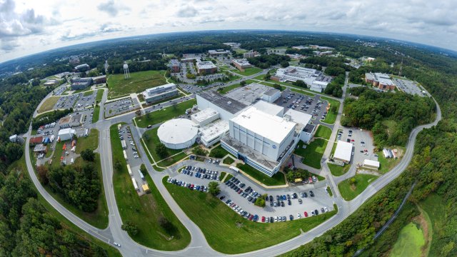 Aerial view of Goddard's campus, with buildings, cars, and green grass.