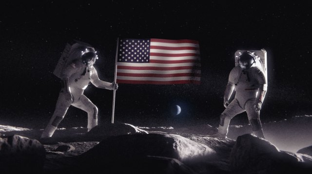 Two astronauts planting an American flag on the surface of the Moon.