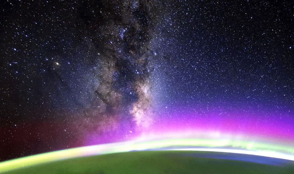 A small part of Earth from space shown in dark green, with light that diffuses into space in shades of violet and dark blue.