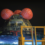The Orion spacecraft floating in the Pacific Ocean after splashdown.