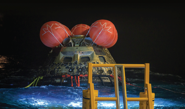 The Orion spacecraft floating in the Pacific Ocean after splashdown.