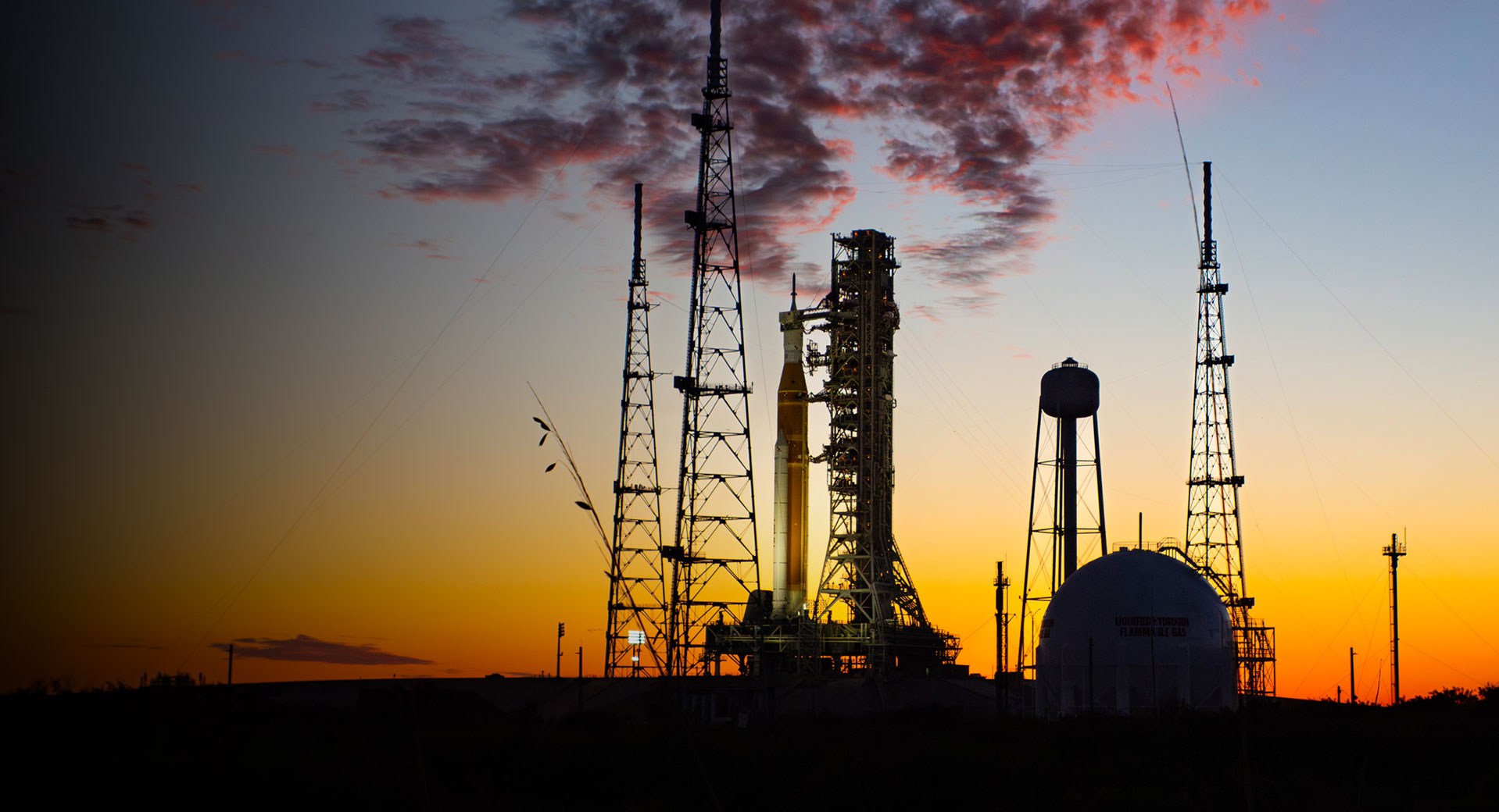 NASA’s Space Launch System rocket and Orion spacecraft on a launch pad at sunset