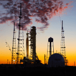 NASA’s Space Launch System rocket and Orion spacecraft on a launch pad at sunset