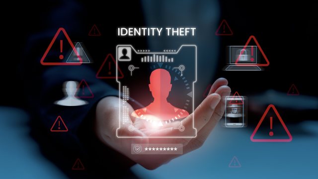 Illustration of a person's silhouette, warning sign icons, and the words "identity theft" above a close-up of a person's hand.